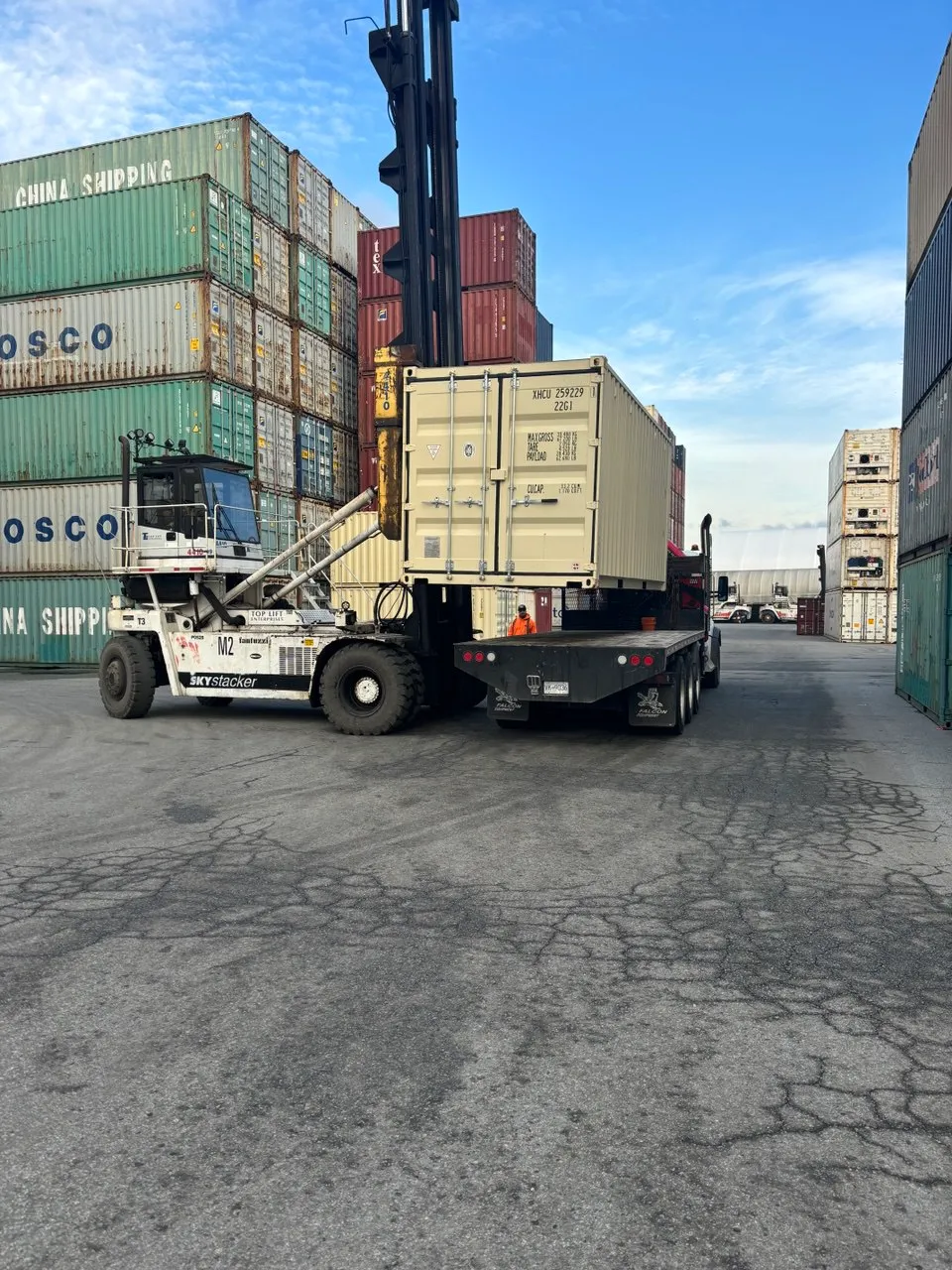 20ft shipping container loaded on a flatbed truck at the depot